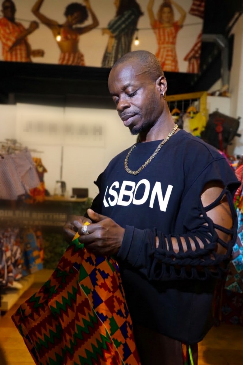 Founder Osei Asibey Bonsu examining kente fabric